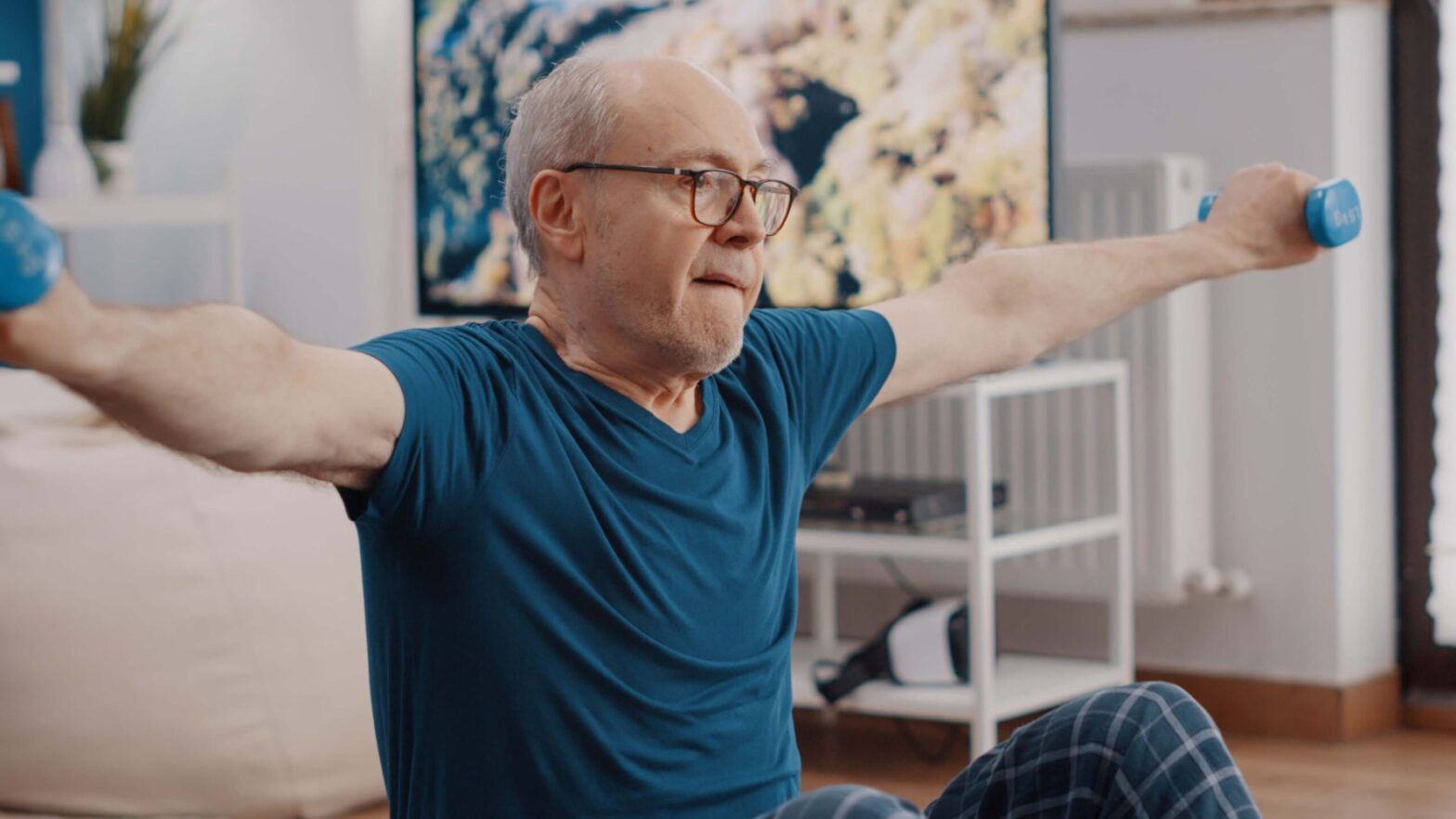 Elderly man exercising with dumbbells