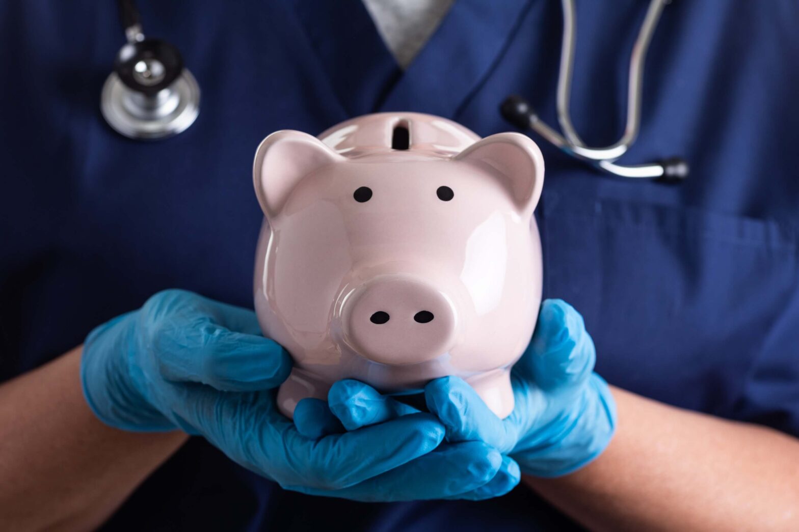 Nurse holding a piggy bank